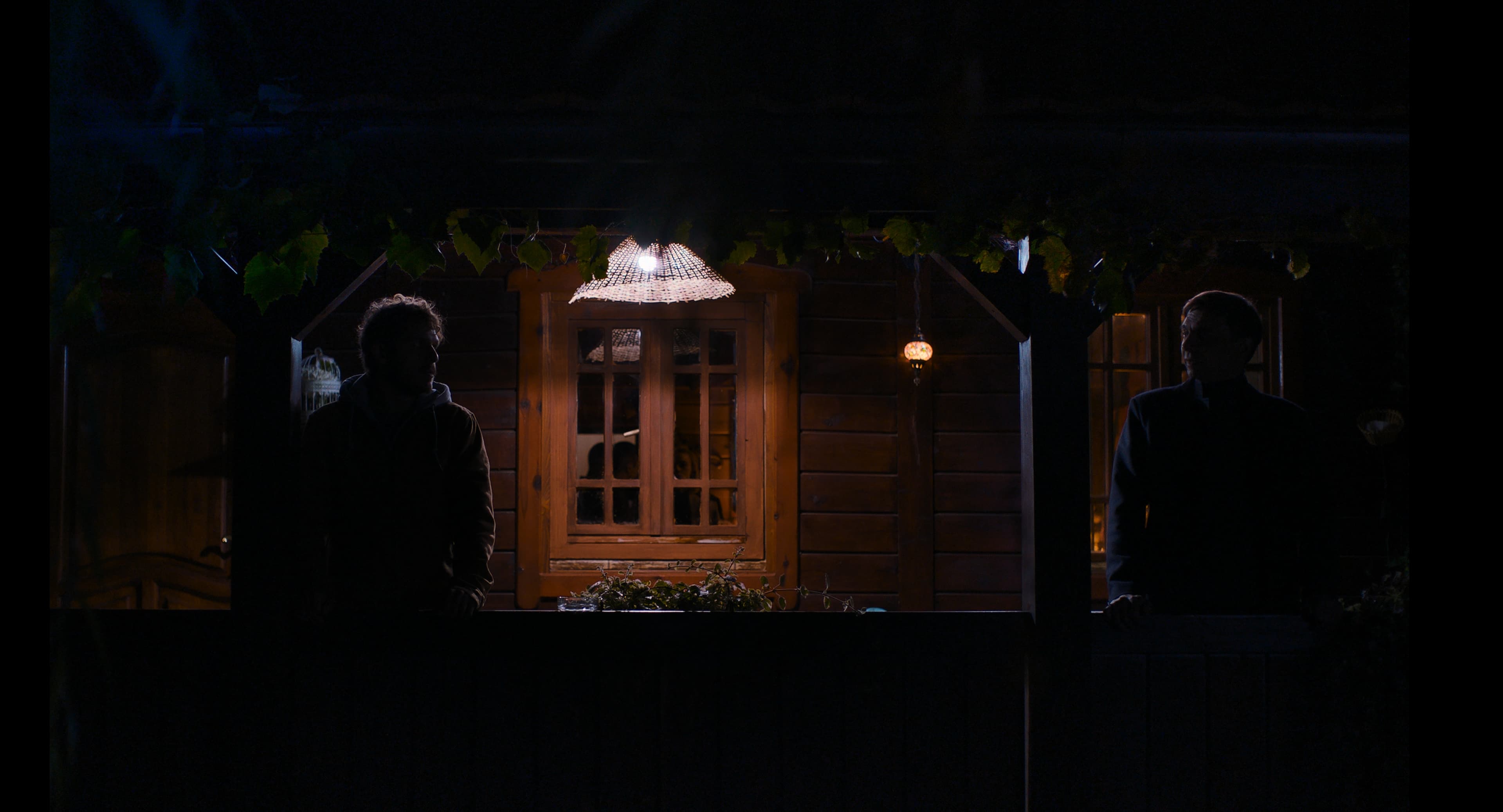 Two characters placed in a restrained, tense scene.